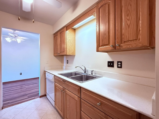 kitchen featuring white dishwasher, a ceiling fan, a sink, and marble finish floor