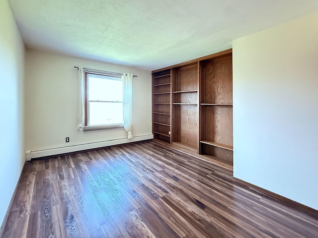 unfurnished bedroom featuring dark wood finished floors, a textured ceiling, baseboards, and baseboard heating