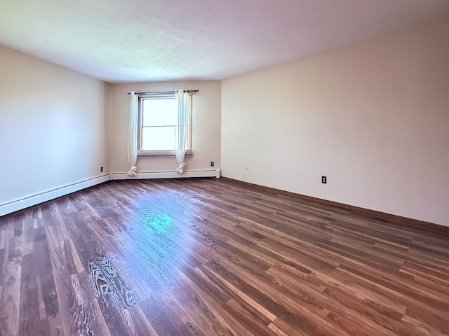 empty room with baseboards and dark wood-style flooring