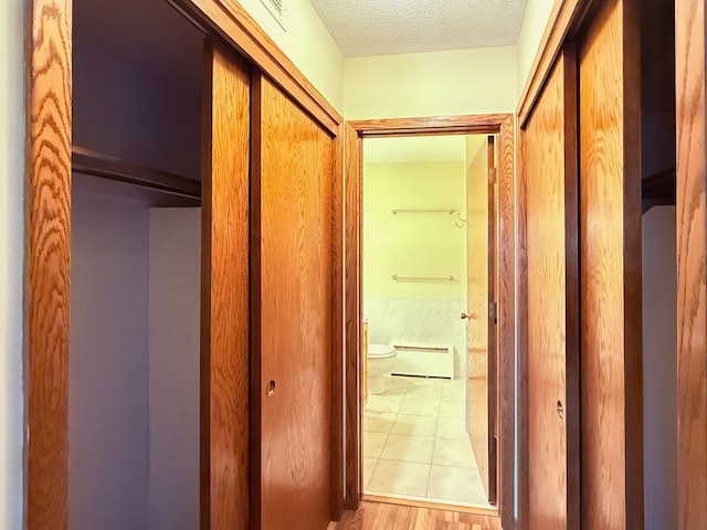 hallway with a textured ceiling
