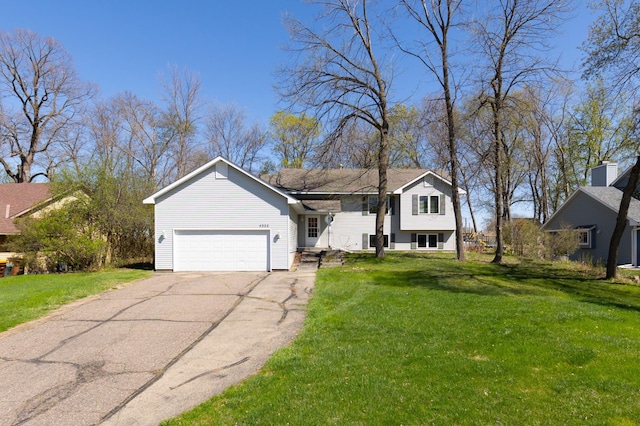 split level home with a garage, driveway, and a front yard