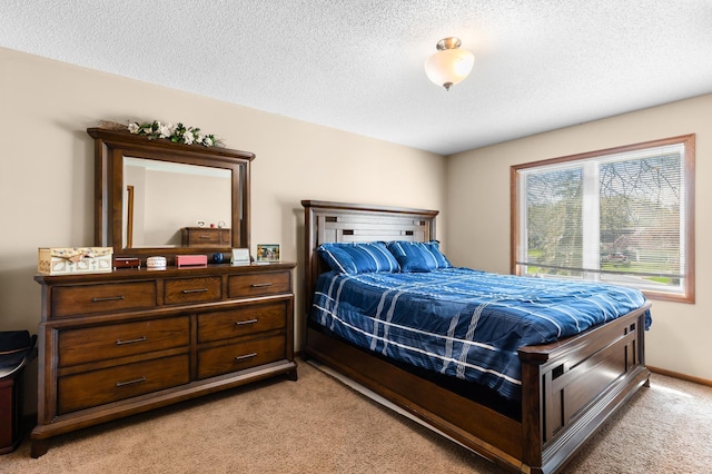 bedroom featuring a textured ceiling and light colored carpet