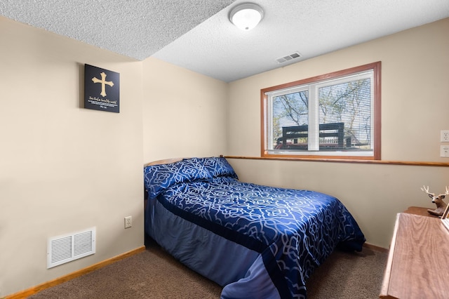 carpeted bedroom featuring baseboards, a textured ceiling, and visible vents