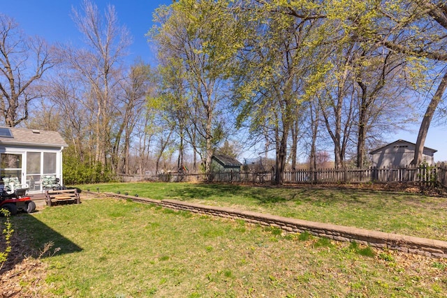 view of yard with a fenced backyard and a sunroom