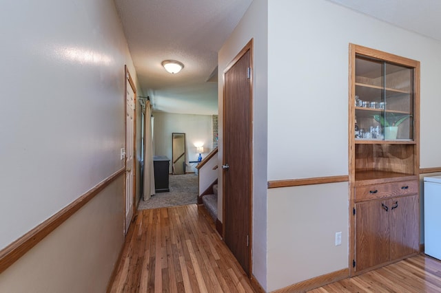 hall featuring light wood finished floors and washer / clothes dryer