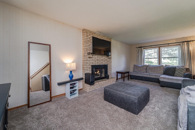 carpeted living area with a fireplace and baseboards