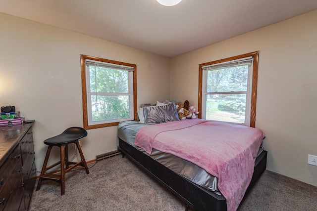bedroom featuring light colored carpet and multiple windows