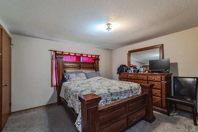 carpeted bedroom featuring a textured ceiling and baseboards
