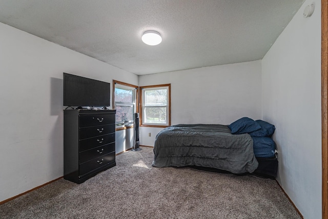 carpeted bedroom featuring a textured ceiling