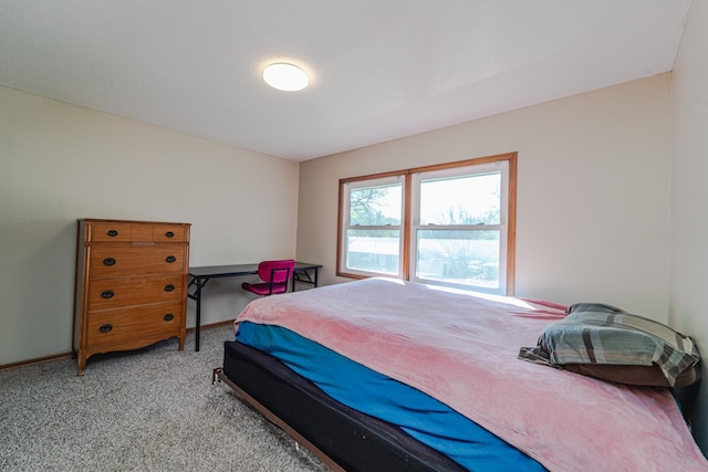 bedroom with light carpet and baseboards