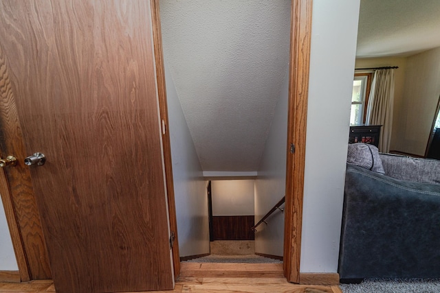 staircase featuring baseboards and wood finished floors
