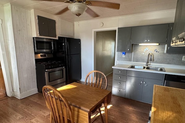 24 3rd Ave S, Sauk Rapids, MN 56379 - kitchen with stainless steel appliances, a sink, gray cabinetry, and dark wood-style floors