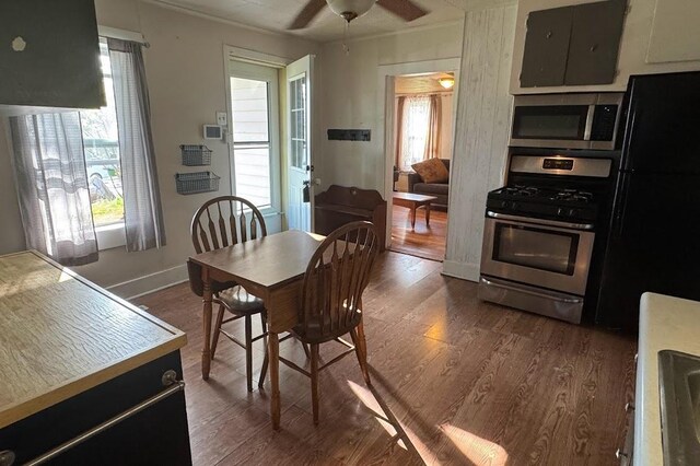 24 3rd Ave S, Sauk Rapids, MN 56379 - dining space with dark wood-style flooring, a ceiling fan, ornamental molding, and baseboards