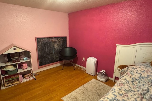 24 3rd Ave S, Sauk Rapids, MN 56379 - bedroom featuring wood finished floors, a textured ceiling, and a textured wall