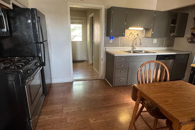 24 3rd Ave S, Sauk Rapids, MN 56379 - kitchen with a sink, stainless steel appliances, gray cabinets, and wood finished floors