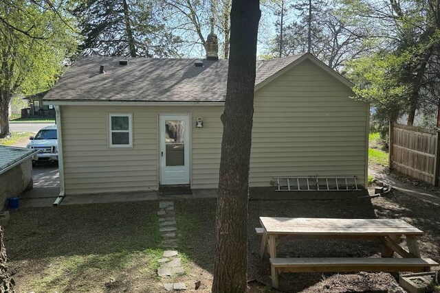 24 3rd Ave S, Sauk Rapids, MN 56379 - back of property with a chimney and a shingled roof