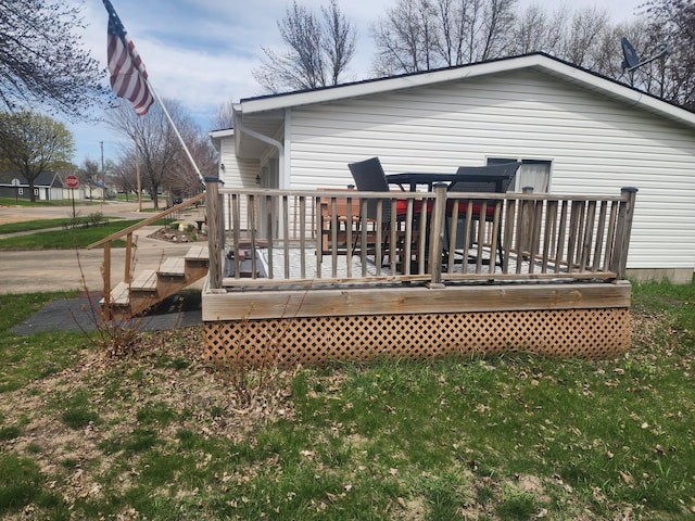 rear view of property featuring a wooden deck
