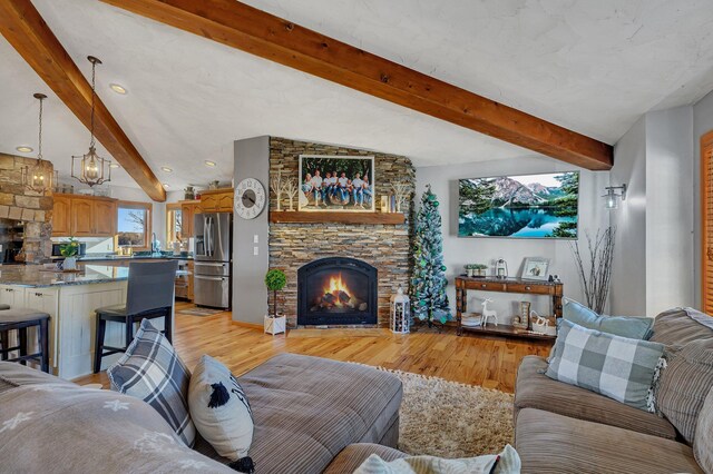 10283 Ferry Point Pl NW, Rice, MN 56367 - living room featuring a fireplace, light wood-style floors, beamed ceiling, and recessed lighting