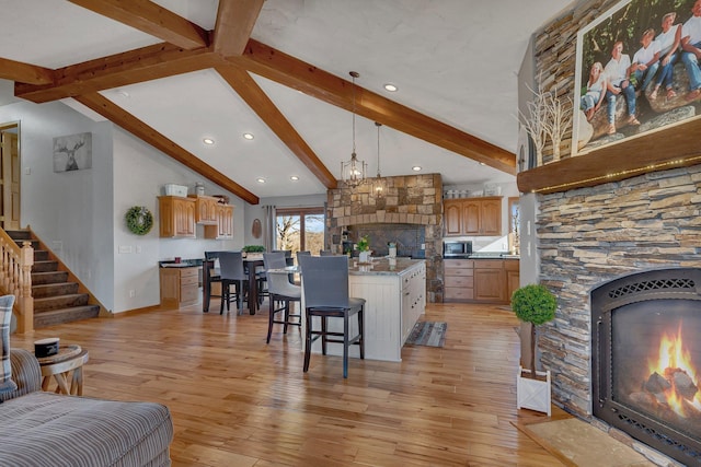 10283 Ferry Point Pl NW, Rice, MN 56367 - living room with a stone fireplace, lofted ceiling with beams, light wood finished floors, and stairs