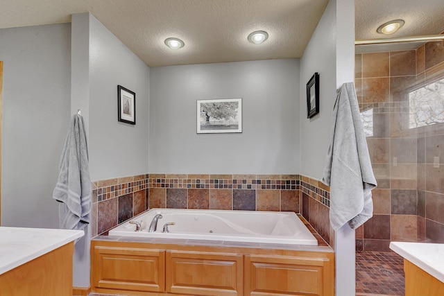 10283 Ferry Point Pl NW, Rice, MN 56367 - full bath with a whirlpool tub, a textured ceiling, tiled shower, and vanity