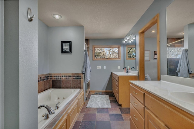 10283 Ferry Point Pl NW, Rice, MN 56367 - full bathroom featuring a tub with jets, a textured ceiling, two vanities, a sink, and a stall shower