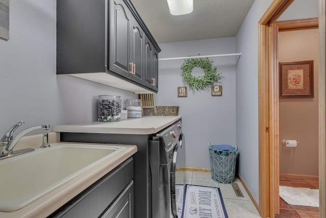 10283 Ferry Point Pl NW, Rice, MN 56367 - laundry area with a textured ceiling, cabinet space, a sink, light tile patterned floors, and washer and dryer