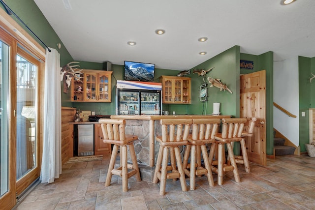 10283 Ferry Point Pl NW, Rice, MN 56367 - bar with indoor wet bar, recessed lighting, stone finish flooring, and stairway