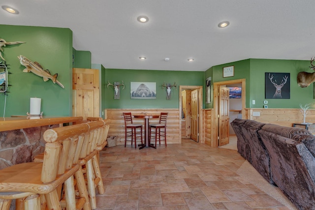10283 Ferry Point Pl NW, Rice, MN 56367 - interior space featuring recessed lighting, stone finish flooring, and wainscoting