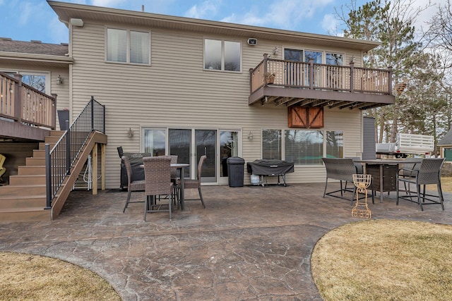 10283 Ferry Point Pl NW, Rice, MN 56367 - back of property with a patio, outdoor dining area, and a balcony