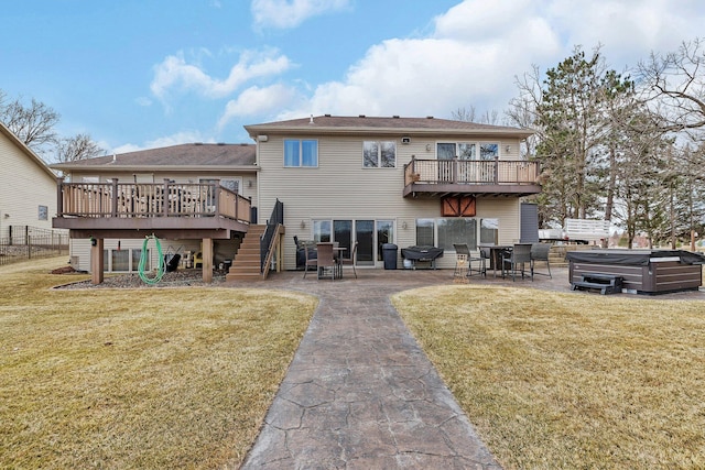 10283 Ferry Point Pl NW, Rice, MN 56367 - back of property featuring a wooden deck, stairs, a hot tub, and a patio area