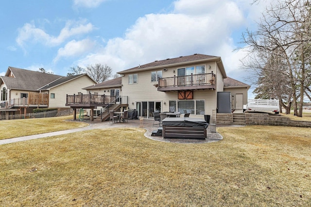 10283 Ferry Point Pl NW, Rice, MN 56367 - back of property with fence, stairs, a patio area, a balcony, and a lawn