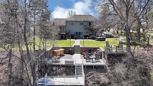 10283 Ferry Point Pl NW, Rice, MN 56367 - back of house with a lawn, a wooden deck, stairs, and a balcony