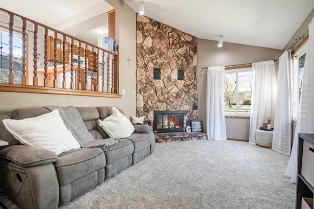 carpeted living room with baseboards, lofted ceiling, and a fireplace