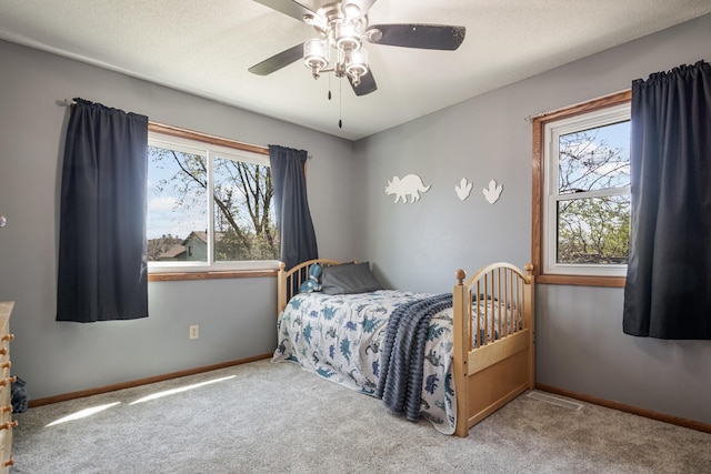 bedroom featuring carpet flooring, a ceiling fan, and baseboards