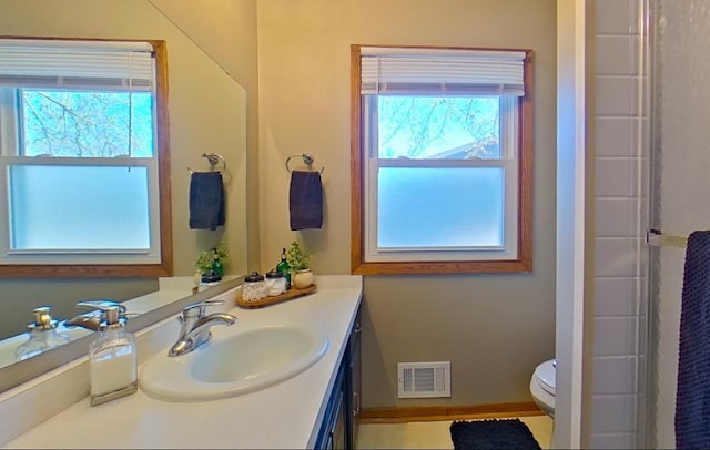 full bathroom with walk in shower, vanity, toilet, baseboards, and visible vents