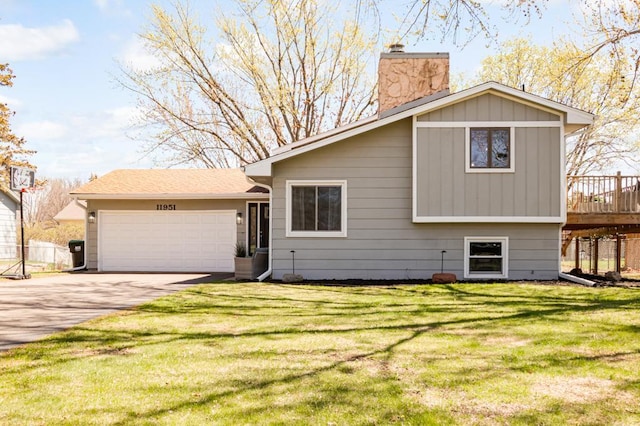 view of front facade featuring a garage, a front yard, a deck, a chimney, and driveway