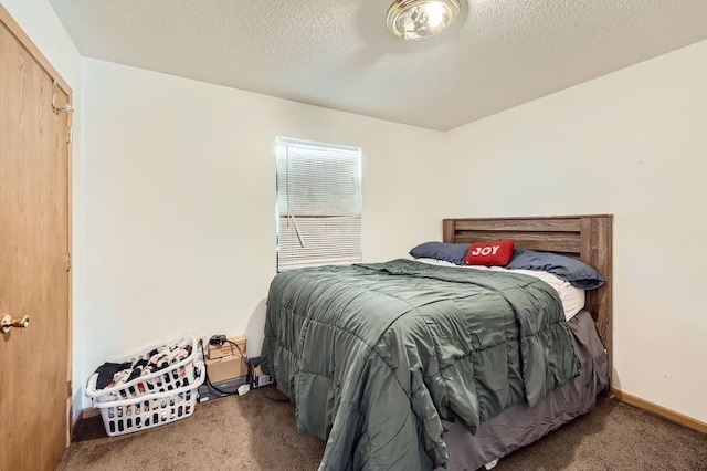 bedroom featuring carpet flooring, a textured ceiling, and baseboards