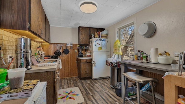 kitchen featuring light countertops, freestanding refrigerator, and light wood-type flooring