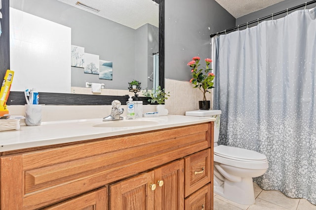 full bath featuring visible vents, vanity, toilet, a textured ceiling, and tile patterned floors