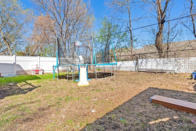 view of yard with a fenced backyard and a trampoline