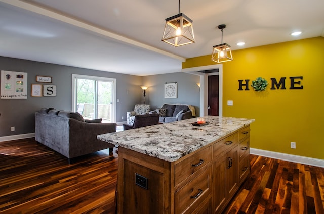 kitchen featuring baseboards, dark wood-style flooring, and open floor plan