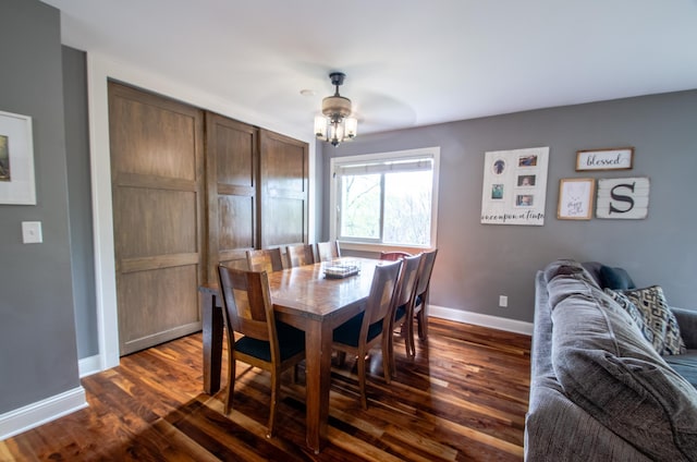 dining area featuring baseboards, a ceiling fan, and dark wood-style floors