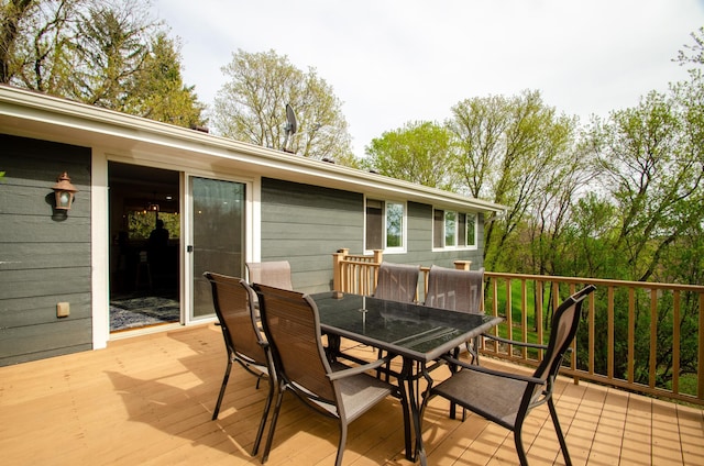 wooden terrace featuring outdoor dining area