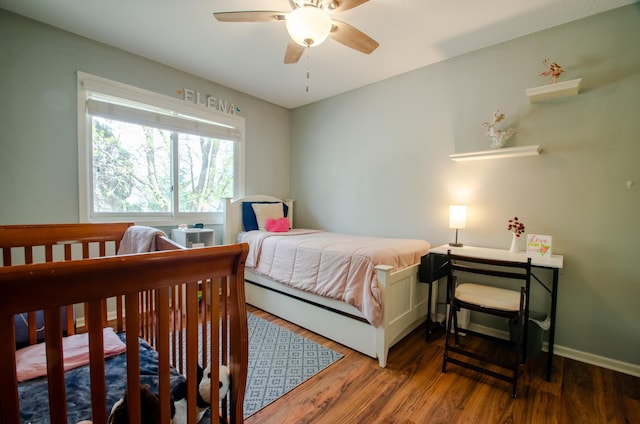 bedroom featuring baseboards, ceiling fan, and wood finished floors