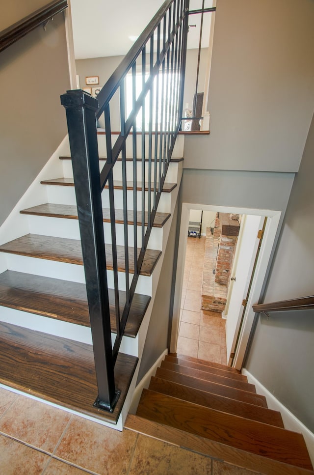 stairway with tile patterned floors