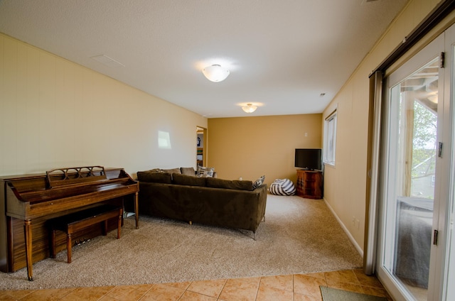 living room featuring light tile patterned floors and light colored carpet