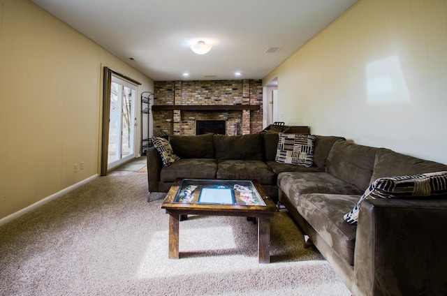 carpeted living room featuring baseboards, visible vents, and a fireplace