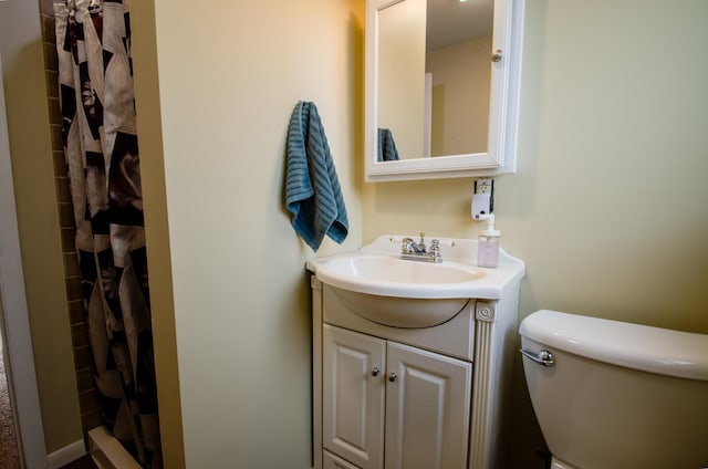 bathroom featuring vanity, toilet, and a shower stall