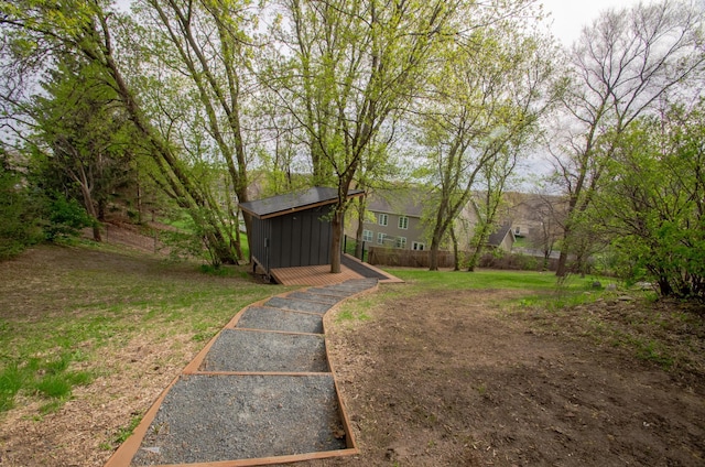 view of yard featuring fence and an outdoor structure