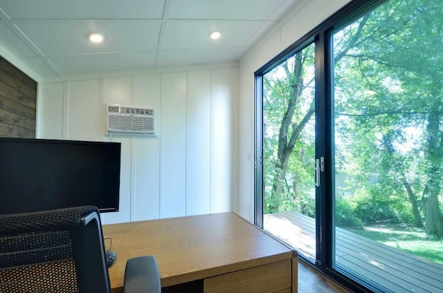office featuring a wall unit AC and a decorative wall